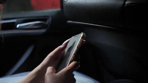 Hand of a young woman using a mobile phone reads a phone message or downloads a Stock-Footage 278252535