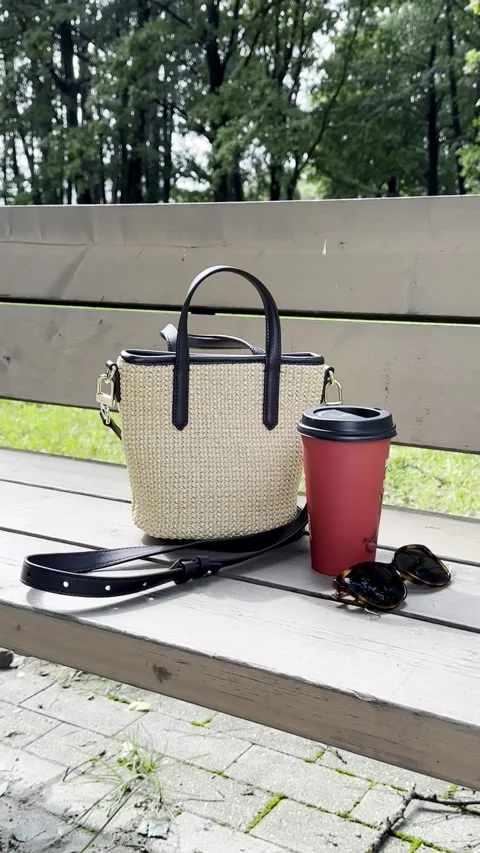 Handbag and Takeaway Coffee Cup on Park Bench, Vertical Video Stock Footage 345043089