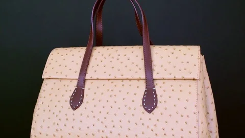 Handbag on black background. Concept for website ladies' accessories - no logo Stock Footage 72547360