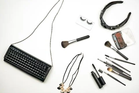 Handbag with makeup set and tools on white Stock Photos