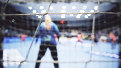Handball match scene with goalpost and players attacking in the background Stock Footage