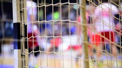 Handball match scene with goalpost net and players in the background 스톡 동영상 70085897