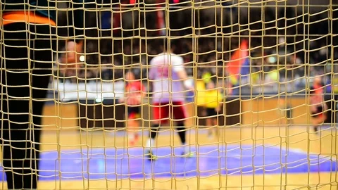 Handball match scene with goalpost net and players in the background 스톡 동영상 70086070