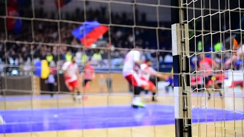 Handball match scene with goalpost net and players in the background Stock Footage 70086360