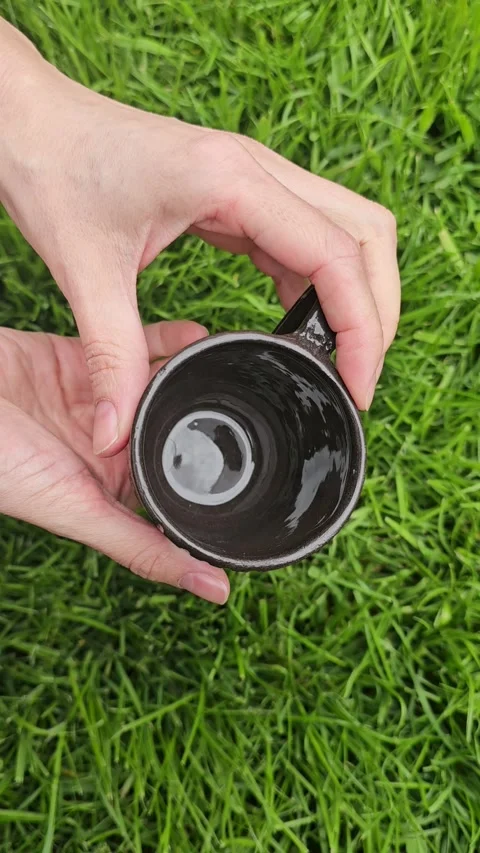 Handcrafted Black Clay Ceramic Cup With Carved Texture Video stock 324531864