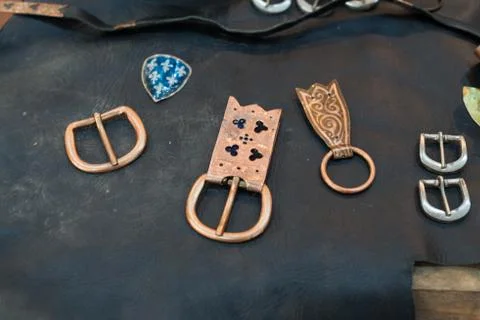 Handcrafted buckle belt on a table in a workshop Stock Photos