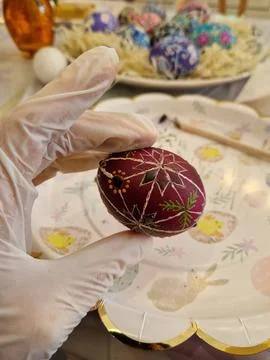 A handcrafted Easter egg is being decorated using the traditional Ukrainian p Stock Photos