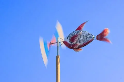 Handcrafted Fish Wind Spinner Spinning Fast In Blue Outdoor Sky Atmosphere Fotos Stock