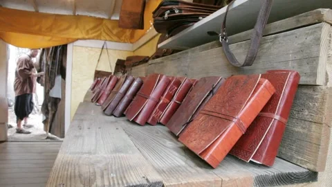 Handcrafted Leather Bound Notebooks on Rustic Wooden Display Stock Footage 345279120