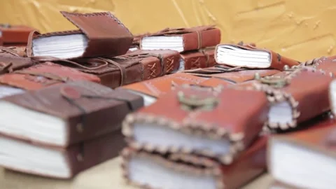 Handcrafted Leather Journals Stacked on Display Stock Footage 345279032