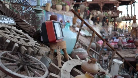 Handcrafted market decor ceramic pots woven baskets wooden wheels colorful fabri Stock Footage 310820396