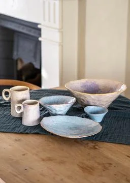 Handcrafted Pastel Ceramic Tableware Set on Rustic Wooden Table Stock Photos