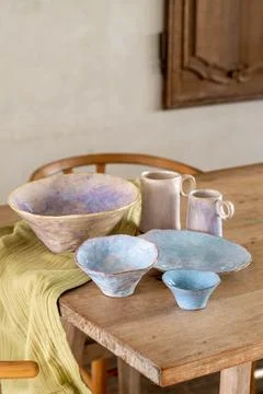 Handcrafted Pastel Ceramic Tableware Set on Rustic Wooden Table Stock Photos