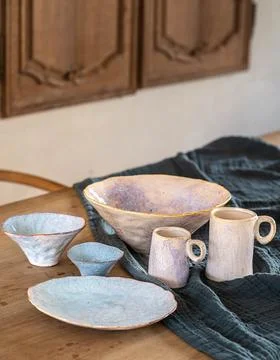 Handcrafted Pastel Ceramic Tableware Set on Rustic Wooden Table Stock Photos