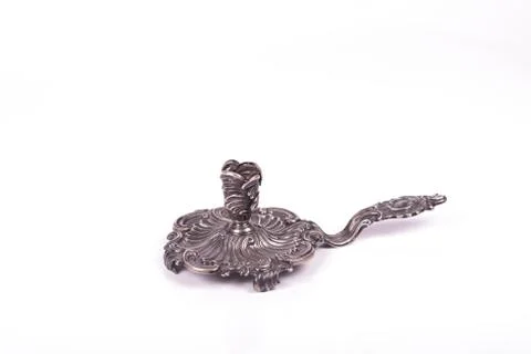 Handcrafted silver candlestick over a white background Stock Photos