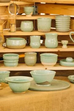 Handcrafted turquoise-painted earthenware vases and plates. Stock Photos