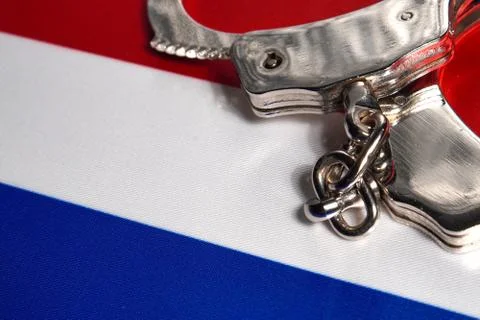 Handcuff on the flag of Netherlands. Close-up, copy space Foto stock