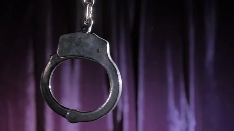 The handcuff sways against the background of the strobe light. Stock Footage 167253586