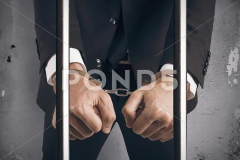 Handcuffed businessman in jail Stock Photos
