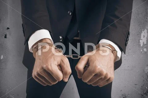 Handcuffed businessman in jail Stock Photos