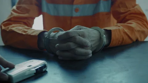 Handcuffed hands beside a recorder Stock Footage 275025679