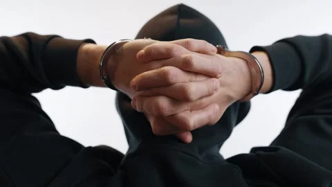 Handcuffed Man Clasping Hands Behind Lowered Head Stock Footage 312473352