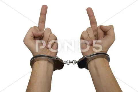 Handcuffed man hands giving a finger isolated over white Stock Photos