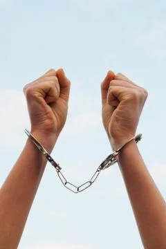 Handcuffed woman's hands Stock Photos