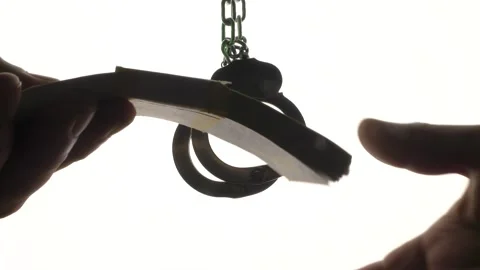 Handcuffing a bribe in the background . Stock Footage 136874579