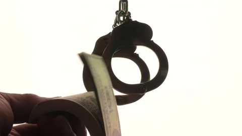 Handcuffing a bribe in the background . Stock Footage 136874594