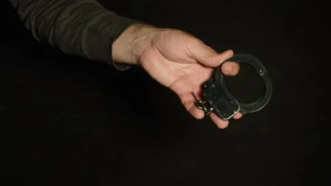 Handcuffs are thrown by hand Stock Footage 89353206