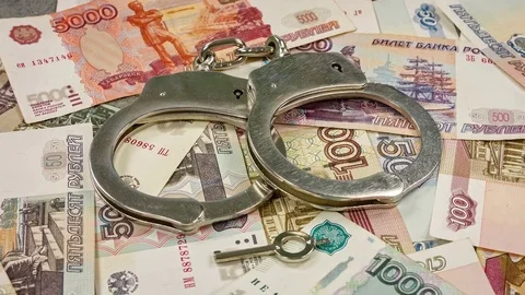 The handcuffs on the background of the Russian ruble. Close up rotation Video stock 79814391