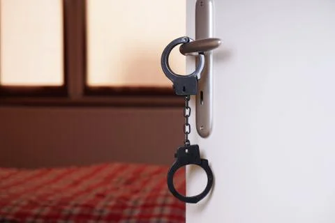 Handcuffs on bedroom door handle Foto stock