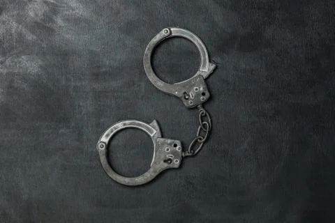 The Handcuffs on black background Stock Photos