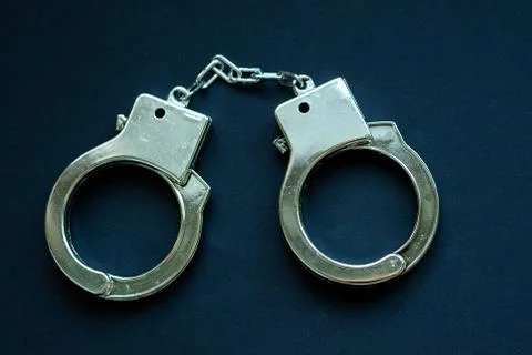 Handcuffs on black Stock-Fotos