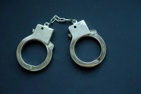 Handcuffs on black Stock Photos