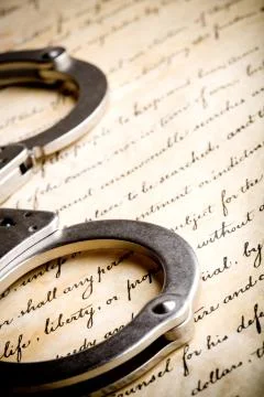 Handcuffs on constitution Stock Photos