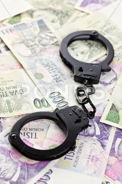 Handcuffs on czech money Stock Photos