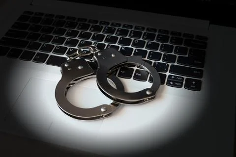 Handcuffs on electronic devices. Stock Photos