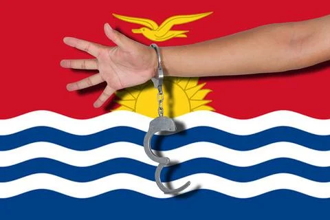 Handcuffs with hand on flag Stock Photos