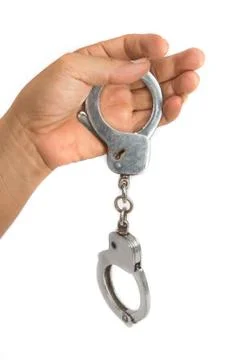 Handcuffs with hand Stock Photos