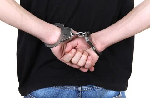 Handcuffs on Hands closeup Stock Photos
