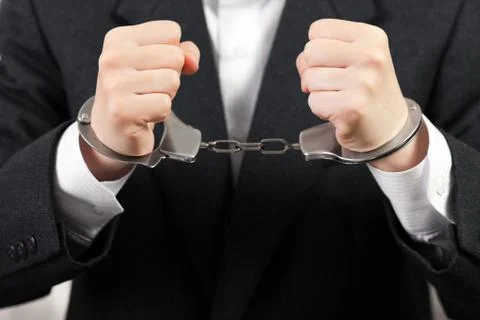 Handcuffs on hands Stock Photos