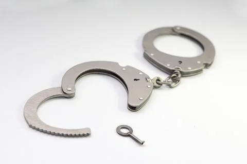 Handcuffs with a key in the form of a heart Foto stock