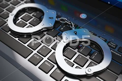 Handcuffs on laptop keyboard Stock Photos