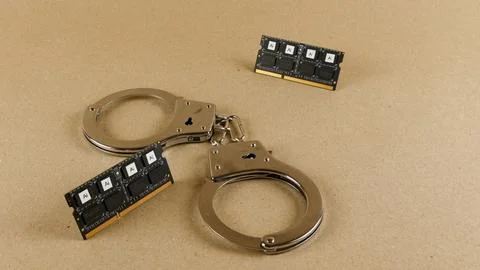 Handcuffs linking AI computer chips representing regulation Stock Photos