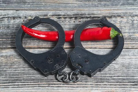 Handcuffs with pepper Stock Photos