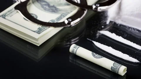 Handcuffs on stack of dollar banknotes and cocaine Stock Footage 150908990