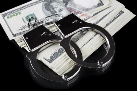 Handcuffs on stack of dollar banknotes and cocaine Photos