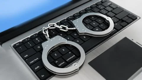 Handcuffs standing on laptop computer keyboard. 3D illustration Stock Illustration